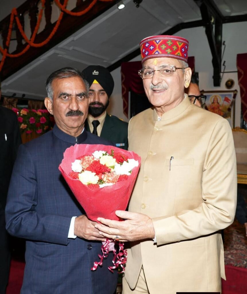 Himachal Pradesh Chief Minister Sukhvinder Singh Sukhu presenting flowers to new Governor Kavinder Gupta during the swearing-in ceremony in Shimla