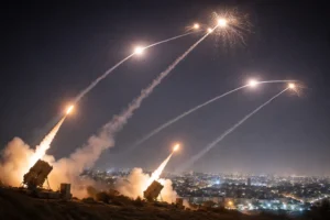Israeli air defense system intercepting incoming missiles over a city during the ongoing conflict with Iran