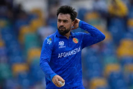 Afghanistan cricketer Rashid Khan holding a cricket ball during an international match.