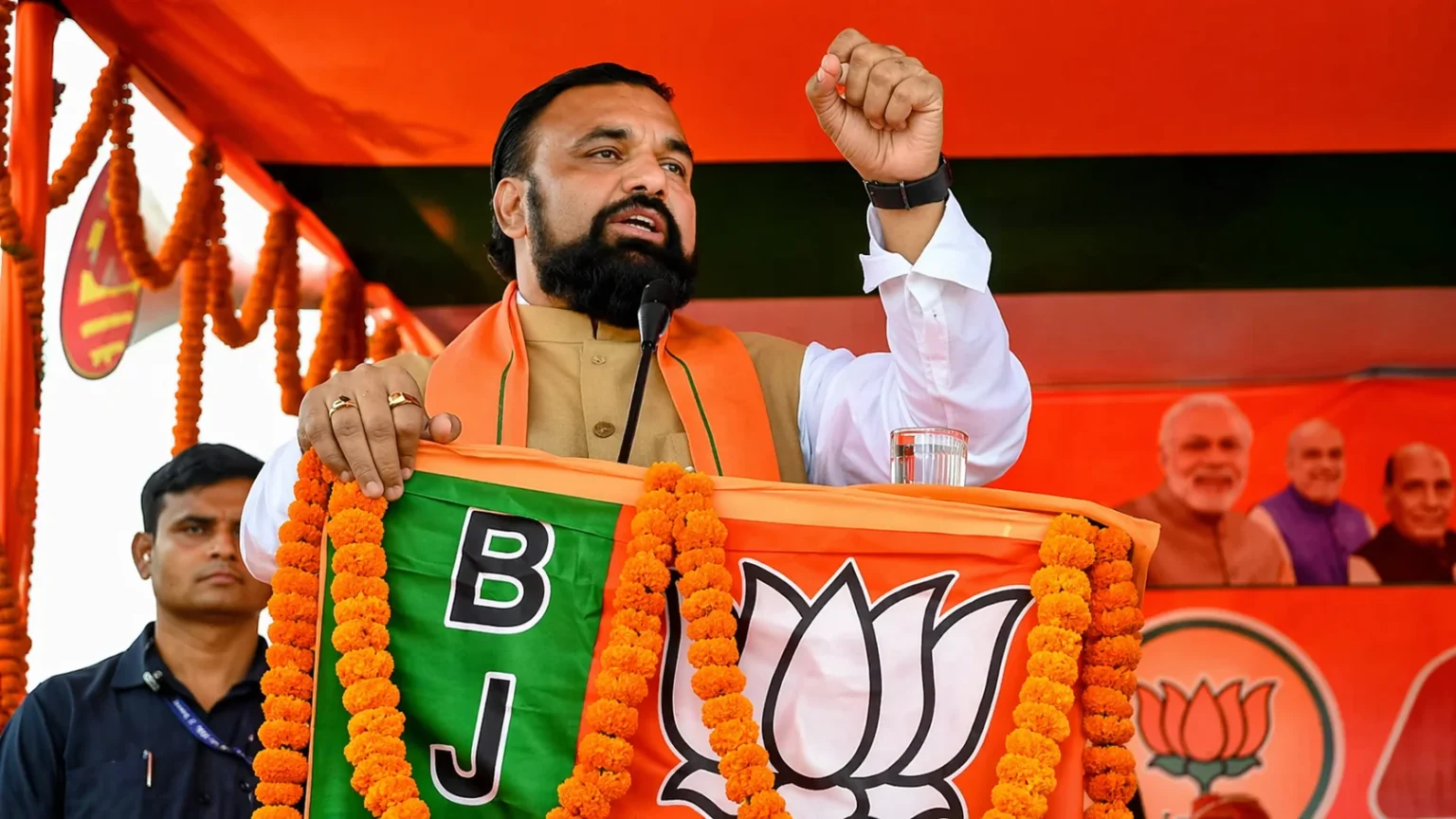 Samrat Choudhary delivering a speech at BJP rally with party flag and lotus symbol in Bihar